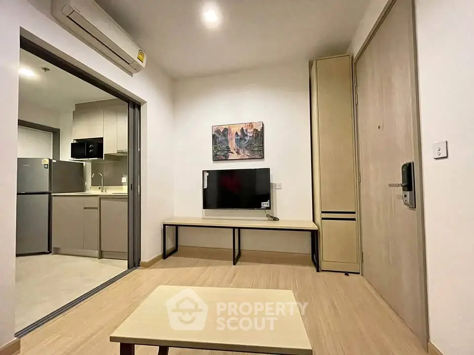 Modern living room with open kitchen and stylish decor in a cozy apartment.
