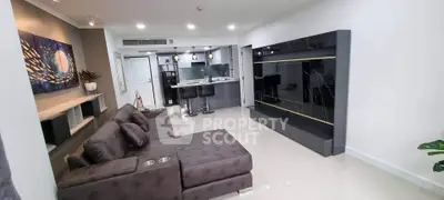 Spacious modern living room with sleek furniture and open kitchen layout