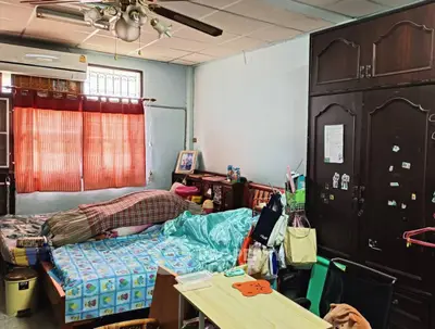 Cozy bedroom with twin beds, ceiling fan, and ample storage space.