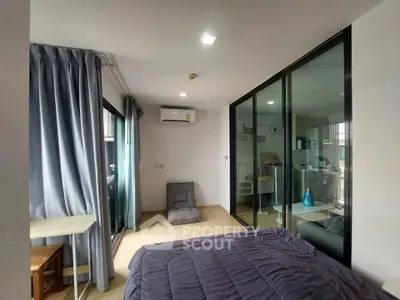 Modern bedroom with glass partition and cozy decor in urban apartment