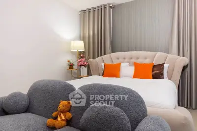 Cozy bedroom with plush bed, elegant curtains, and stylish decor accents.