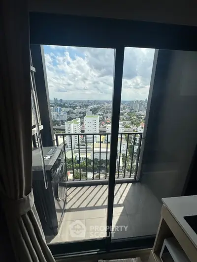 Stunning high-rise balcony view with cityscape and modern washing machine.