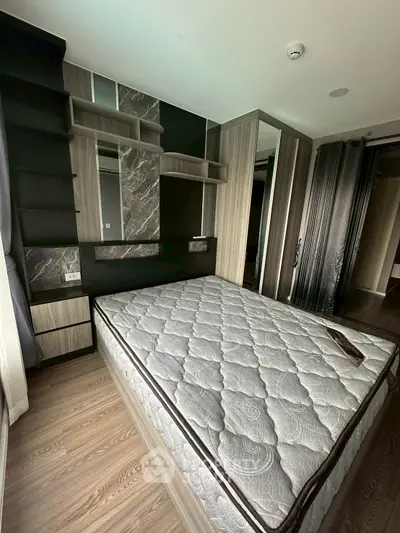 Modern bedroom with stylish decor and comfortable mattress in a contemporary apartment.