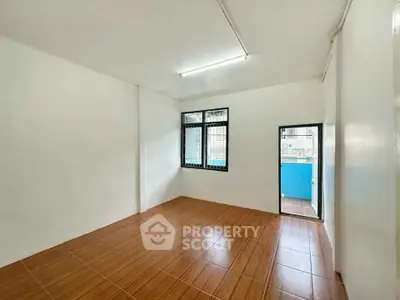 Spacious room with tiled floor and natural light, ideal for versatile use.