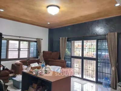 Spacious living room with large windows and cozy seating area