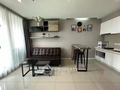 Modern living room with sleek furniture and open kitchen layout