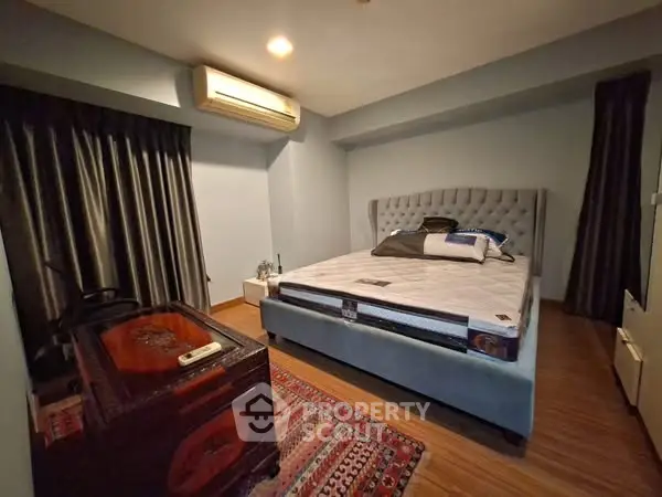 Cozy bedroom with modern furniture and air conditioning, perfect for relaxation.