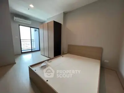 Spacious bedroom with modern design and balcony access in a stylish apartment.