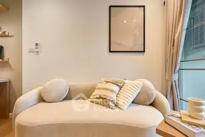 Modern living room with stylish sofa and elegant decor in a cozy apartment setting.