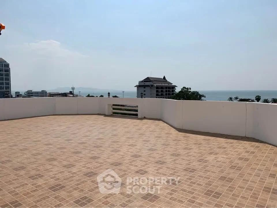Spacious rooftop terrace with stunning ocean view, perfect for relaxation and entertainment.