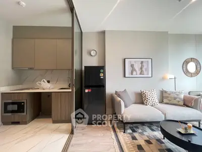 Modern open-layout living room with sleek kitchen and stylish decor