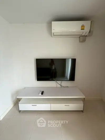 Modern minimalist living room with wall-mounted TV and air conditioning