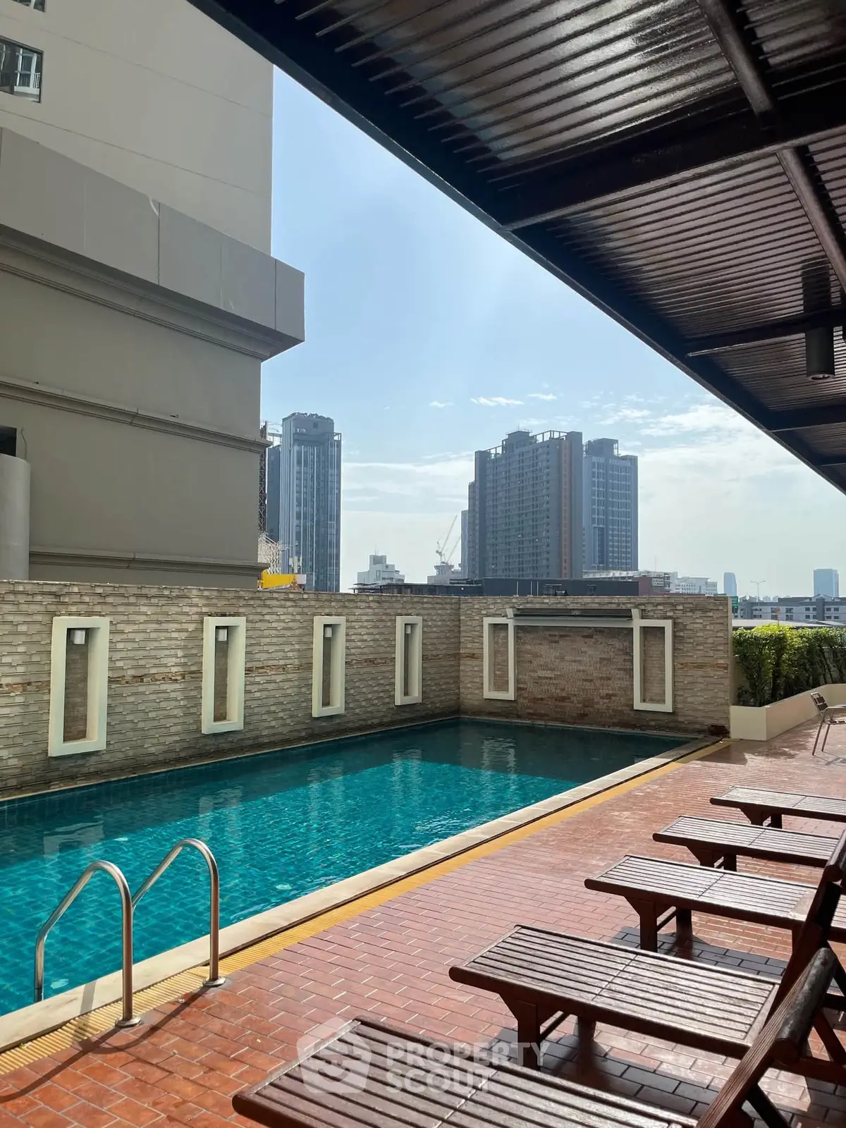 Luxurious rooftop pool with city skyline view, perfect for relaxation and leisure in urban living.