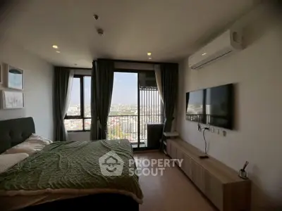 Modern bedroom with city view, featuring large window and sleek decor.