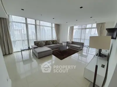 Spacious modern living room with panoramic city views and elegant furnishings.