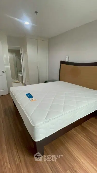 Spacious bedroom with modern design and comfortable mattress in a stylish apartment.