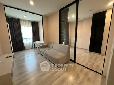 Modern living room with sleek design and glass partition in a stylish apartment.