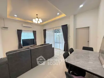 Spacious modern living room with elegant lighting and large windows for natural light.