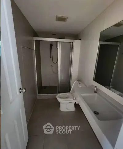 Modern bathroom with shower and sleek fixtures in a contemporary home.