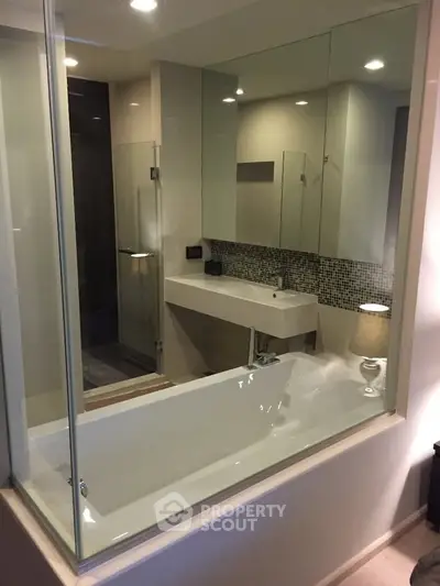 Modern bathroom with glass partition and sleek fixtures