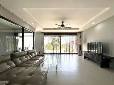 Spacious modern living room with large windows and sleek furniture
