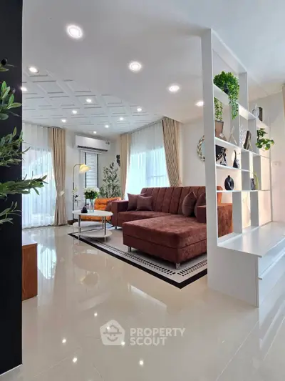 Modern living room with stylish decor and large windows for natural light.