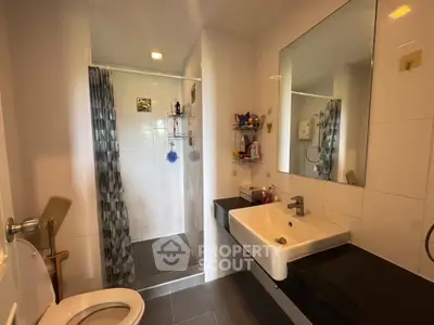 Modern bathroom with sleek fixtures and spacious shower area