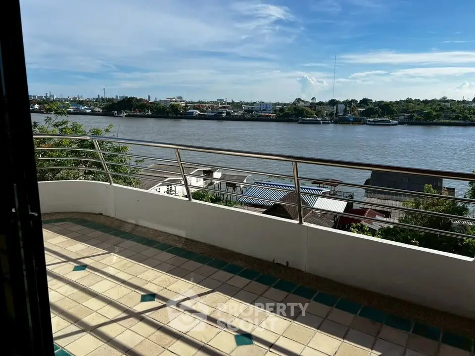 Stunning river view from spacious balcony with modern railing and tiled floor.