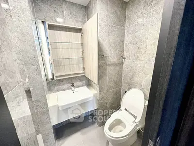 Modern bathroom with sleek gray tiles and contemporary fixtures