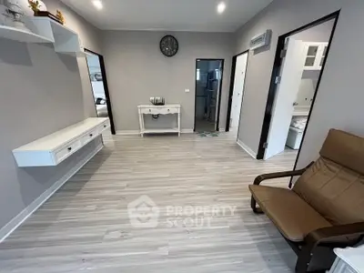 Spacious modern living room with sleek flooring and stylish furniture in a contemporary apartment.