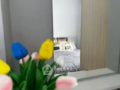 Stylish bedroom with modern decor and vibrant tulip arrangement