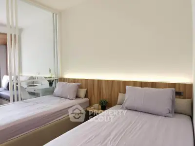 Modern bedroom with twin beds and mirrored closet in stylish apartment