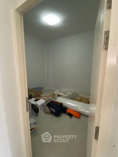 Small storage room with boxes and miscellaneous items, ideal for organizing household goods.