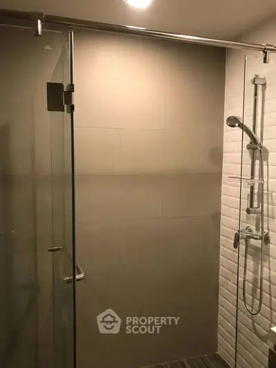 Modern bathroom with glass shower enclosure and sleek fixtures