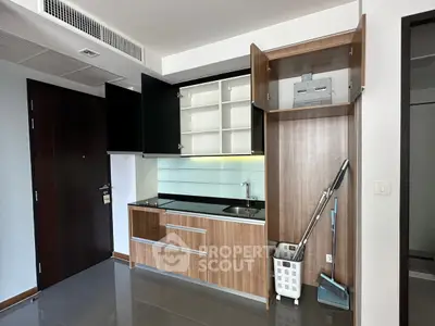 Modern kitchen with sleek cabinets and integrated appliances in a stylish apartment.