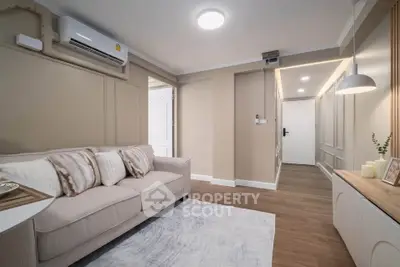 Modern living room with cozy sofa and stylish decor in a well-lit apartment.