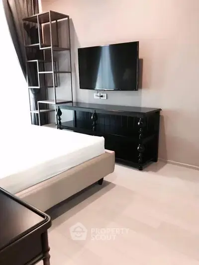 Modern bedroom with sleek TV setup and stylish furniture