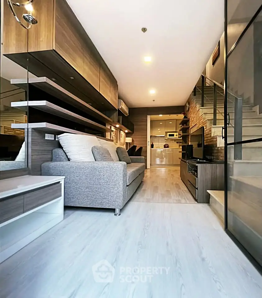 Modern living room with stylish decor and open layout, featuring sleek furniture and ambient lighting.