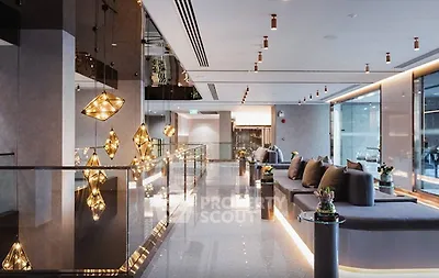 Luxurious modern lobby with elegant lighting and plush seating in a high-end building.