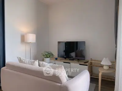 Cozy living room with modern decor and flat-screen TV