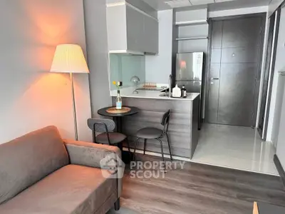 Modern studio apartment with cozy living area and compact kitchen, perfect for urban living.