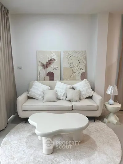 Stylish modern living room with cozy white sofa and unique coffee table, perfect for relaxation.