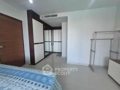 Modern bedroom with sleek wardrobe and minimalist decor