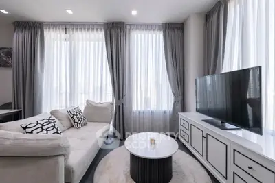 Modern living room with elegant decor and large windows