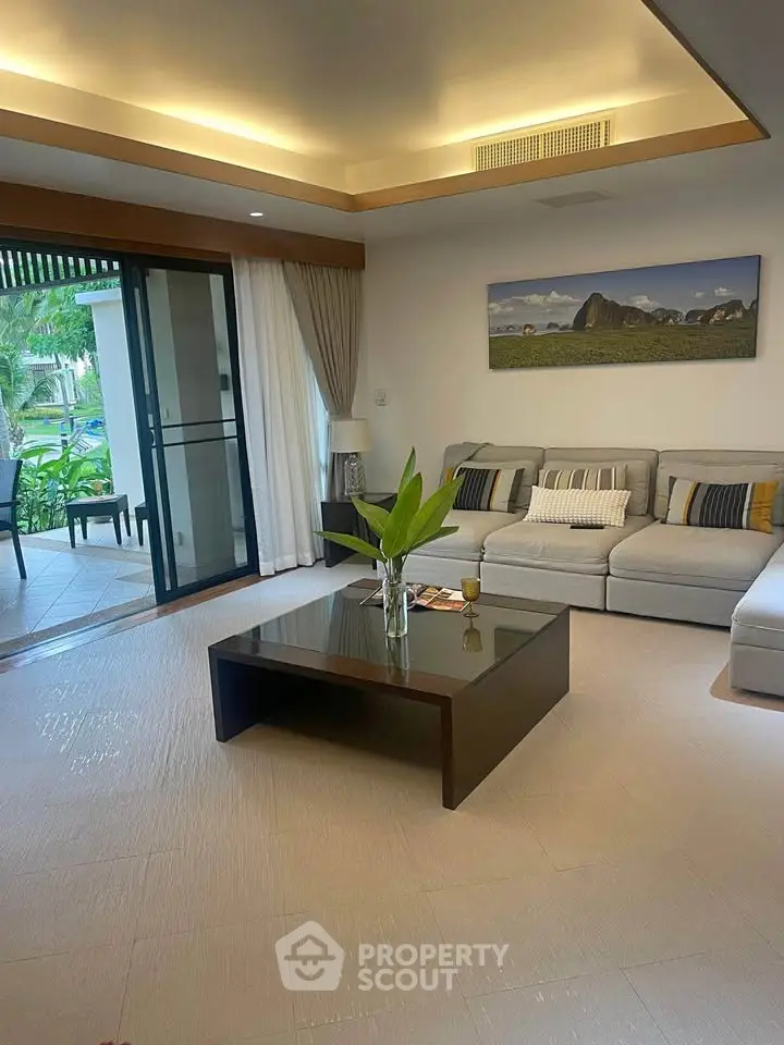 Spacious living room with modern decor and garden view, perfect for relaxation.