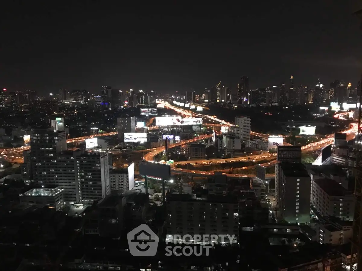 Stunning cityscape view with illuminated skyline and bustling highways at night.