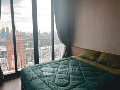 Modern bedroom with stunning city view from large windows and elegant decor.
