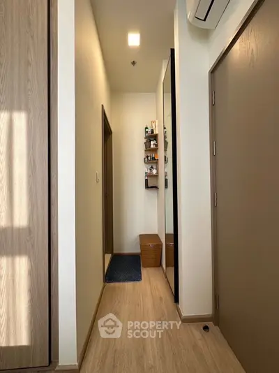 Modern hallway with wooden flooring and sleek storage solutions