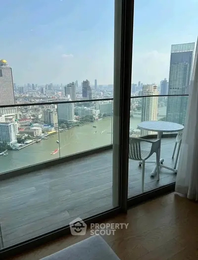 Stunning high-rise balcony with breathtaking city and river views, perfect for relaxation and entertainment.