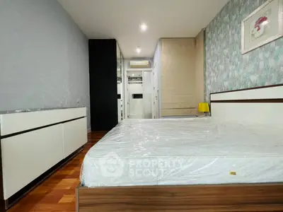 Spacious modern bedroom with stylish decor and ample storage space